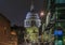 View onto the famous St. Paul\'s Cathedral in city center at sunset lit up with night lights in London, England