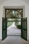 View through open gate of a formal garden