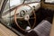 View on opened window with the steering wheel and the interior of the old Russian car of the executive class released in the