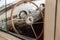 View from opened window with the steering wheel and the interior of the old Russian car of the executive class released in the