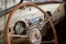 View from opened window with the steering wheel and the interior of the old Russian car of the executive class released in the