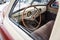 View from opened window with the steering wheel and the interior of the old Russian car of the executive class released in the