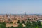 View of the orange medieval skyline of Bologna with brick buildings, seen from the arbours leading to the sanatorium