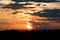 View of orange sunlight and dark clouds and mountain in evening time