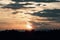 View of orange sunlight and dark clouds and mountain in evening time