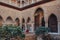 View of ornate arches of Patio de Maidens courtyard inside Alcazar of Seville, Spain