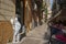 View of Orologio street in Palermo, Sicily with the tables prepared for food and the church tower in the background