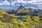 View at Ossau valley from the mountain pass Ayous in Franch Atlantic Pyrenees, as seen in October. Lake Gentau is at foreground of