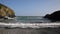 View out to sea from Cadgwith Cornwall England UK with waves crashing towards camera