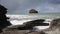 View out to sea to Gull Rock with waves crashing on the rocks Trebarwith Strand Cornwall England UK coastal village