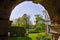 View of outdoor backyard in springtime through the arch of the building