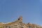 View of outer wall of stone old tower of fortress in spanish desert