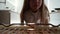 View from the oven: long haired teen girl opens the oven\'s door and puts a baking pan inside. Beautiful girl on kitchen