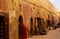 View over alley in medina of arabic oriental berber town on brown clay facades of shops