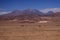 View over barren plain on brown hills contrasting with deep blue sky - Salar Salt flat near San Pedro de Atacama - Chile