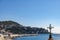 View over a bay in front of Nice, France, with a crucifix in the foreground.