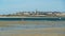 View over bay during low tide from Dinard on cityscape of breton town Saint Malo against dizzy sky