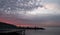 View over the Bay of Naples near Sorrento, Italy at sunset. Piers in silhouette.