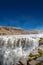 View over biggest and most powerful waterfall in Europe called Dettifoss in Iceland, near lake Myvatn, at blue sky, summer