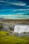 View over biggest and most powerful waterfall in Europe called Dettifoss in Iceland, near lake Myvatn, at blue sky, summer