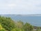 View over bushes at Moushole to the blue sea of the Cornish coast and Saint Michael\\\'s Mount Cornwall England