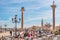 View over cafe at the famous San Marco square in Venice, Italy, with two symbols of Venice, winged lion and Saint Theodore killing