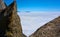 View over the clouds with rocks in the foreground