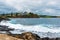 View over coastline, water waves and rocky shore in Kiama, NSW, Australia