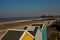 A view over Cromer beach and the beach huts and pier on a bright day