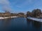 View over Danube River in winter with snow-covered riverbank and bare trees in the evening sun in Sigmaringen, Baden-WÃ¼rttemberg.