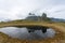 View over Eystrahorn mountain chain who reflects in little pond