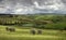 View over fields, vineyards, olive groves and farmhouses south of Pienza in Val D`Orcia San Quirico Tuscany Italy