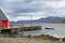 View over the fjord with a wooden jetty, and beautiful mountains & islands in the background, Eskifjordur, East Iceland