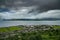 View over Greenock town with the river Clyde and mountains in the background on a gloomy day