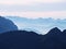 View over high sharp mountain peaks from plane, beautiful view. Fantastic dreamy sunrise