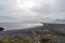 View over Hvalnes beach ,the atlantic ocean and black lava sand with foot prints all over.