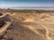 View over the Jordanian desert over the irrigated plantations and the saltworks at the Dead Sea with the coast of Israel in the