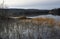 View over lake in autumn with seaweed in foreground