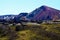 View over lava field on rugged red mountain range