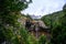 View over Mangawhero Falls rushing down from 20m height of the rocks into a small river. Magnificent peaks of Mt Ruapehu