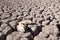 View over parched and empty dam, with cracked mud