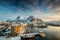 View over the port of Svolvaer on the Lofoten islands in colorful early morning sunrise in winter with snow