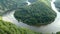 View over the Saar river loop next to Mettlach in Saarland Germany. tourist boat driving on river.