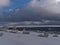 View over Schliffkopf , Germany in Black Forest with hotel building and snow-covered meadow with frozen trees in deep snow.