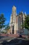 View over square on tower of medieval gothic protestant church from 14th century against blue summer sky