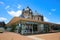 View over square on transparent modern glass pavilion  theater speelhuis with old church against blue sky in summer