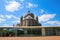 View over square on transparent modern glass pavilion  theater speelhuis with old church against blue sky in summer