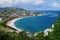 A view over St. Kitts Island with residential area and beaces on the foreground and lush green hills on the background