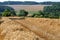 View over stubble field to hilly rural landscape