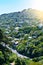 View over valley road and green slopes covered with cosy suburbuan houses in Wellington, New Zealand.